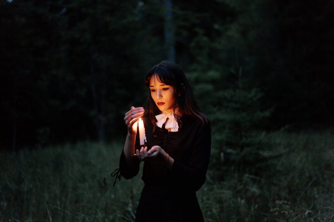 woman in black long sleeve shirt standing on green grass field