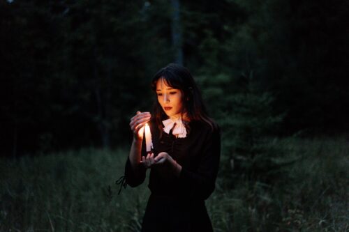 woman in black long sleeve shirt standing on green grass field