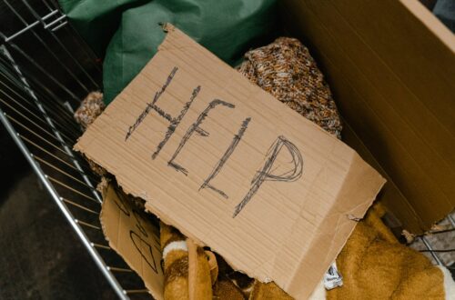a cardboard with the word help written