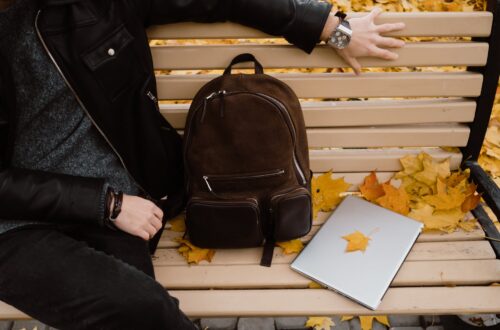 person sitting on a wooden bench