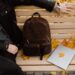 person sitting on a wooden bench