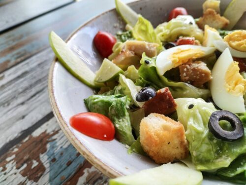 close up photo of vegetable salad with boiled egg